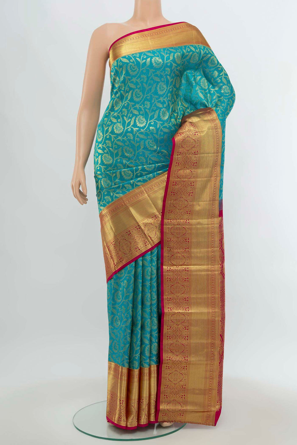 Light Blue Kanchipuram Silk Saree with Zari Butta on the body and Silk Border.  displayed on a mannequin