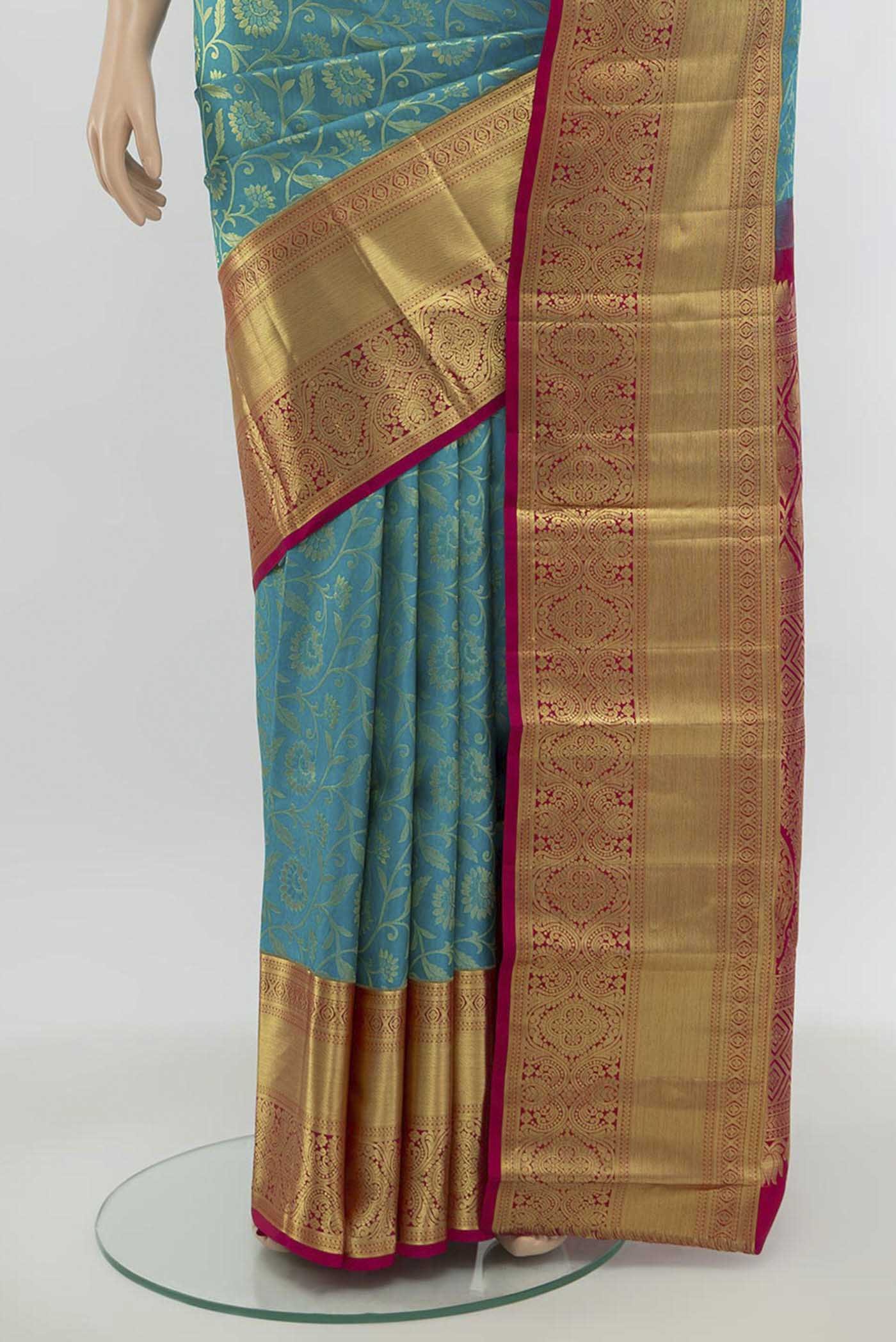 Pleats and pallu of Light Blue Kanchipuram Silk Saree with Zari Butta on the body and Silk Border. 