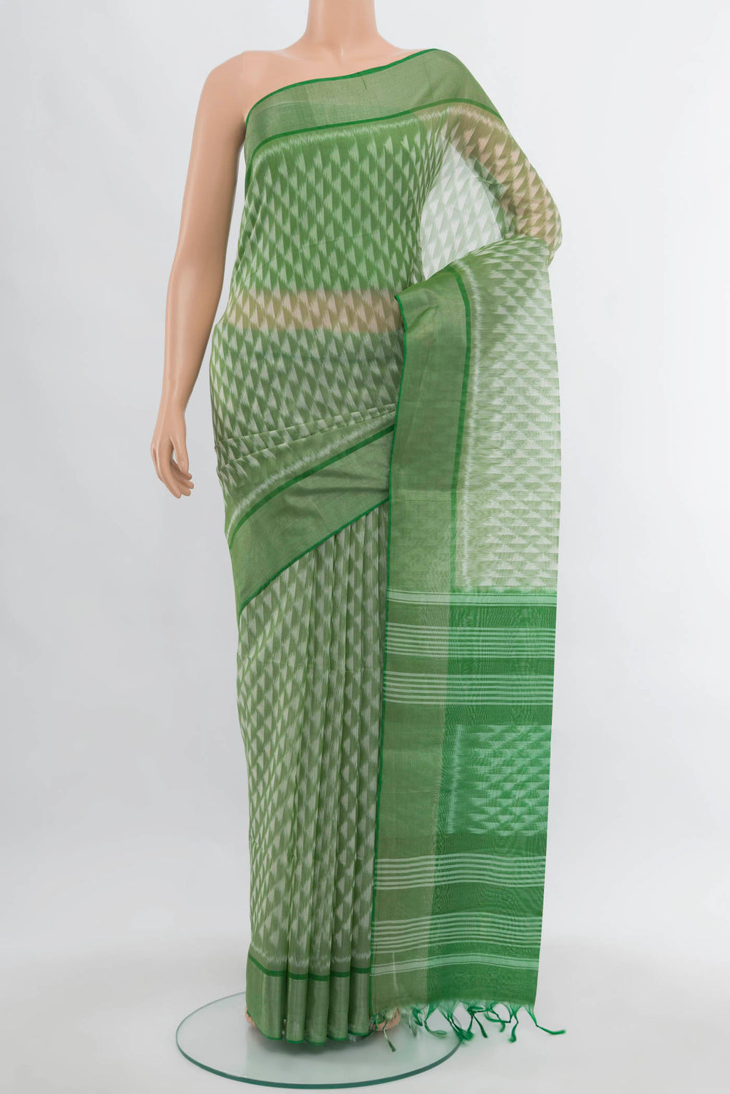 Light Green Kora Cotton Saree with Zari Butta on the body and Silk Border.  displayed on a mannequin