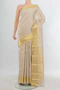 Beige Kanchipuram Silk Saree with Zari Butta on the body and Zari Border.  displayed on a mannequin