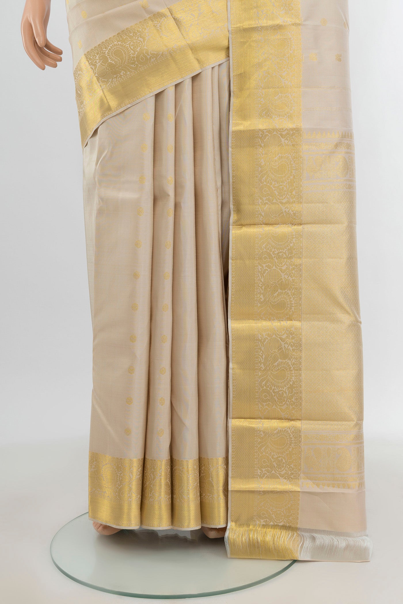 Pleats and pallu of Beige Kanchipuram Silk Saree with Zari Butta on the body and Zari Border. 