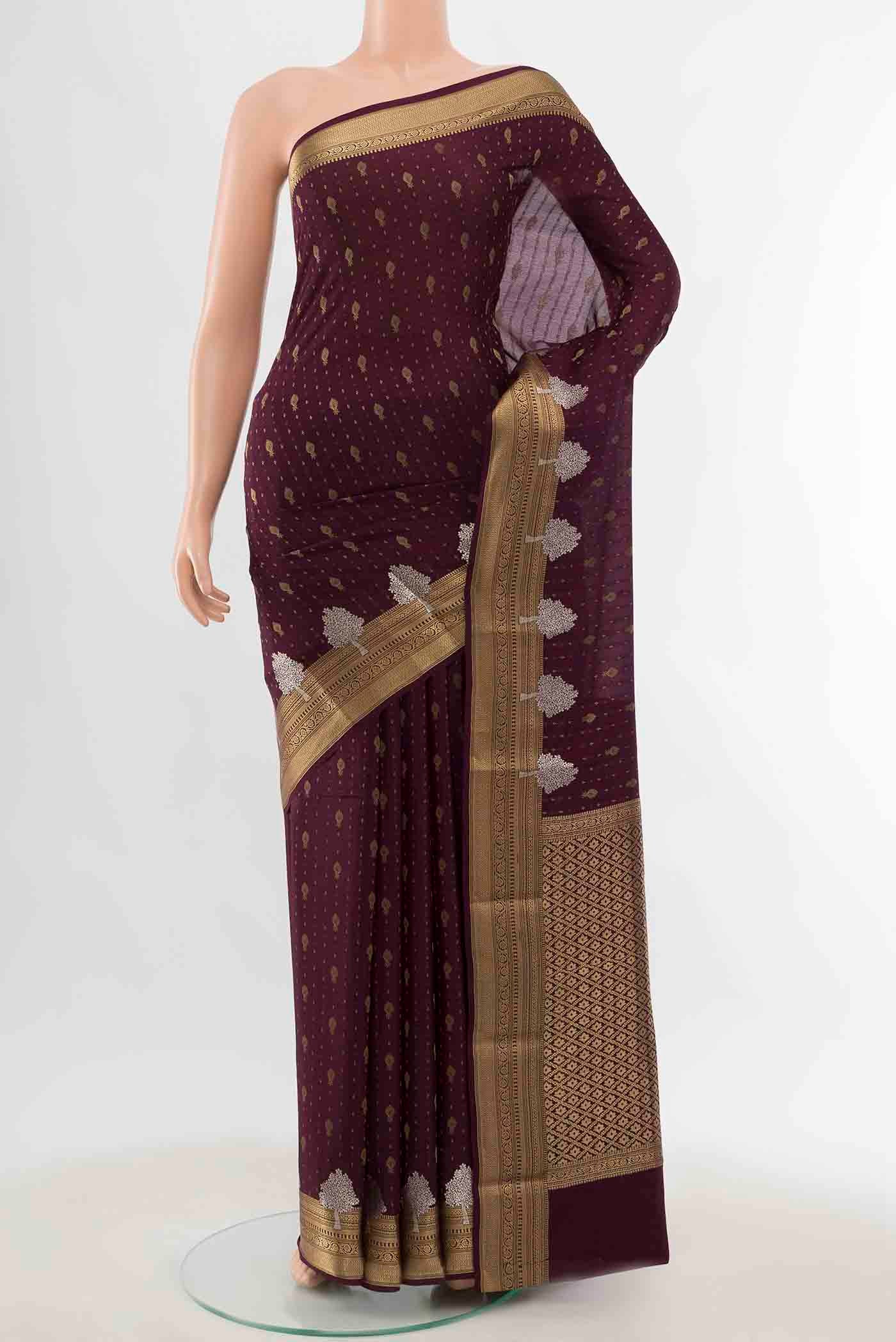 Coffee Brown Mysore Crepe Saree with Zari Butta on the body and Zari Border displayed on a mannequin