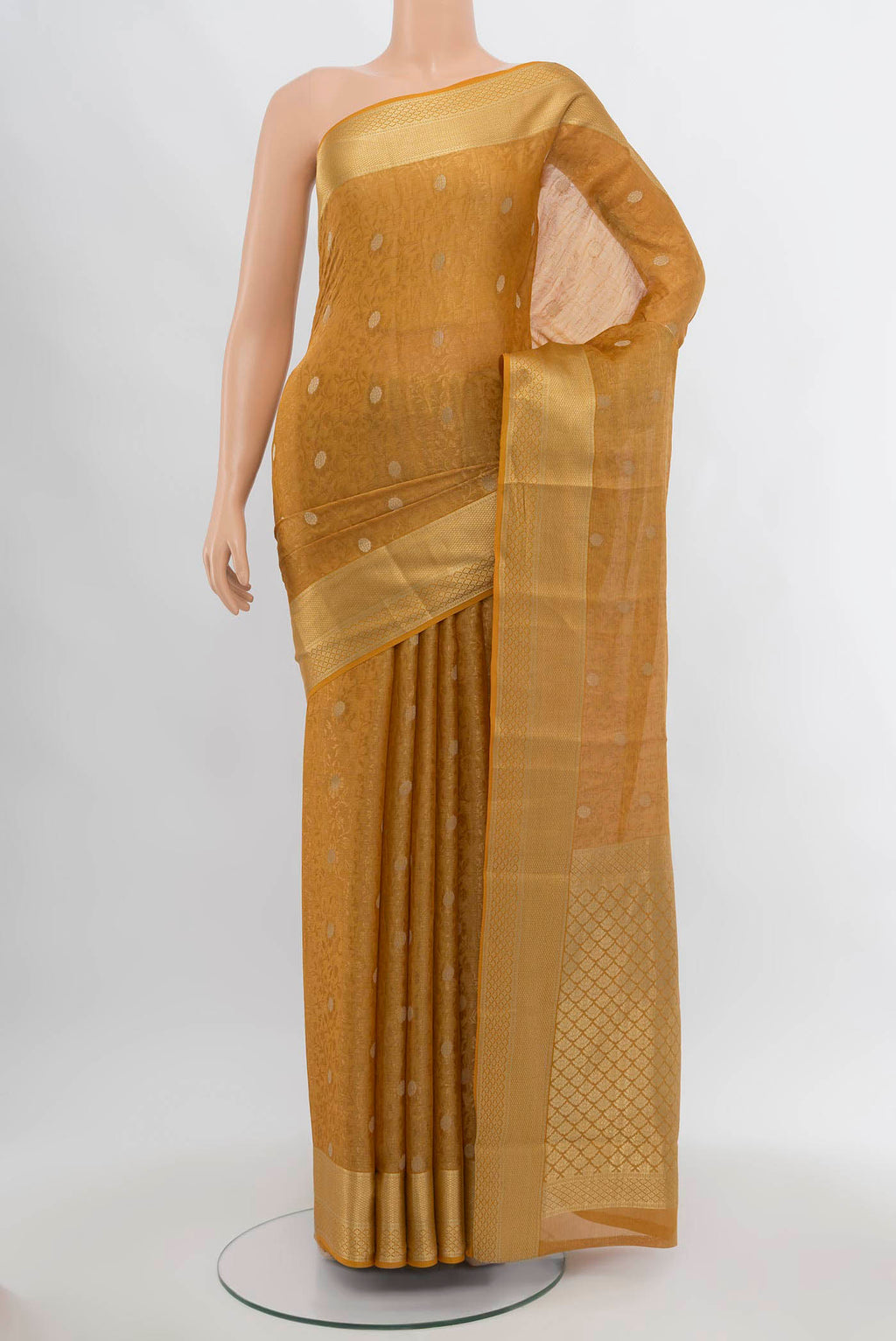Mustard Mysore Crepe Saree with Zari Butta on the body and Silk Border.  displayed on a mannequin