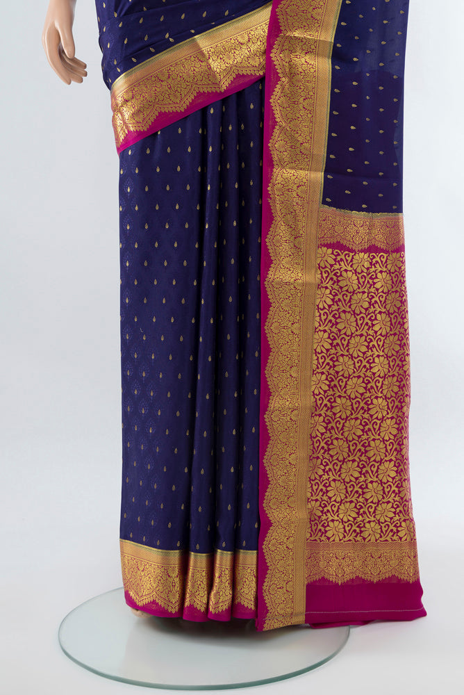 Pleats and pallu of Dark Blue Mysore Crepe Saree with Zari Butta on the body and Silk Border. 