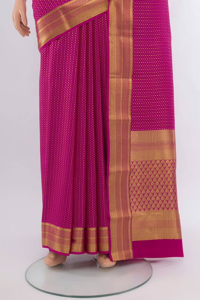 Pleats and pallu of Magenta Mysore Crepe Saree with Zari Butta on the body and Silk Border. 