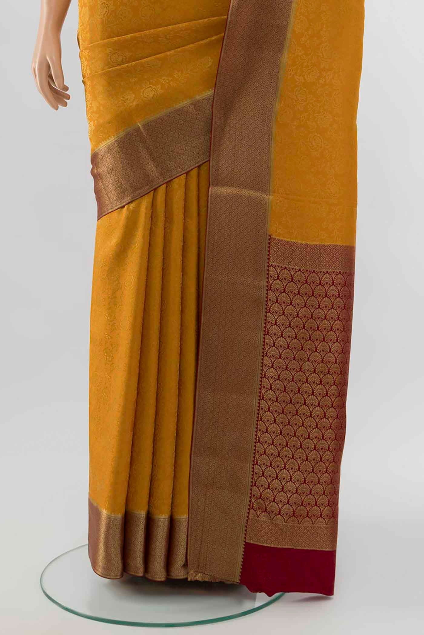 Pleats and pallu of Mustard Mysore Crepe Saree with Zari Butta on the body and Silk Border