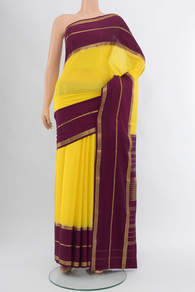 Lemon Yellow Mysore Crepe Saree with Plain Body and Silk Border.  displayed on a mannequin