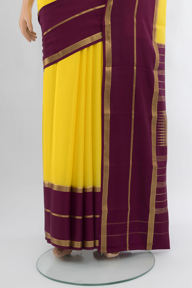 Pleats and pallu of Lemon Yellow Mysore Crepe Saree with Plain Body and Silk Border. 