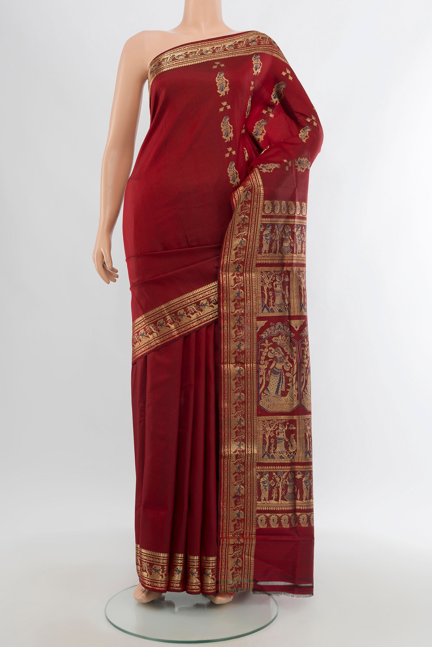 Maroon Baluchari Silk Saree with Zari Butta on the body and Zari Border.  displayed on a mannequin