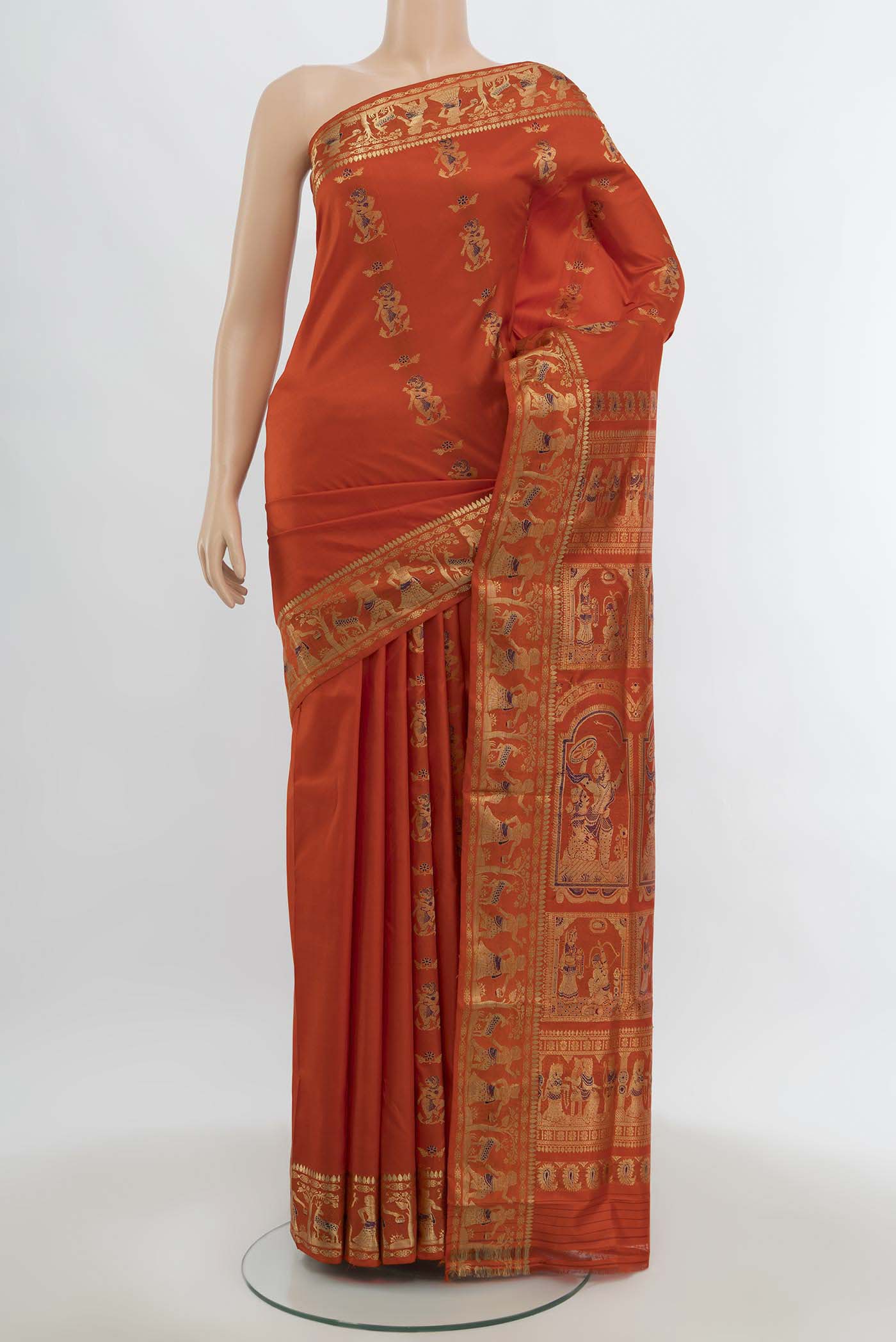 Orange Baluchari Silk Saree with Zari Butta on the body and Silk Border.  displayed on a mannequin