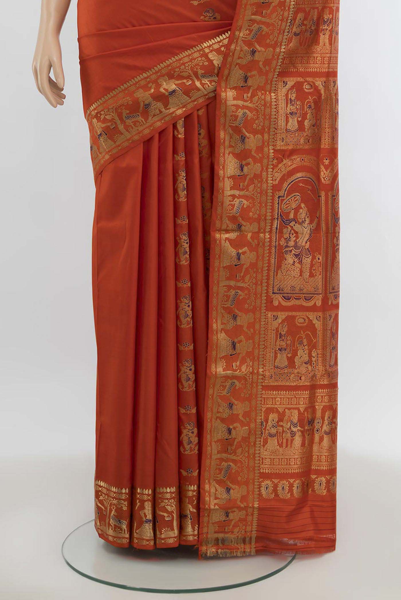 Pleats and pallu of Orange Baluchari Silk Saree with Zari Butta on the body and Silk Border. 