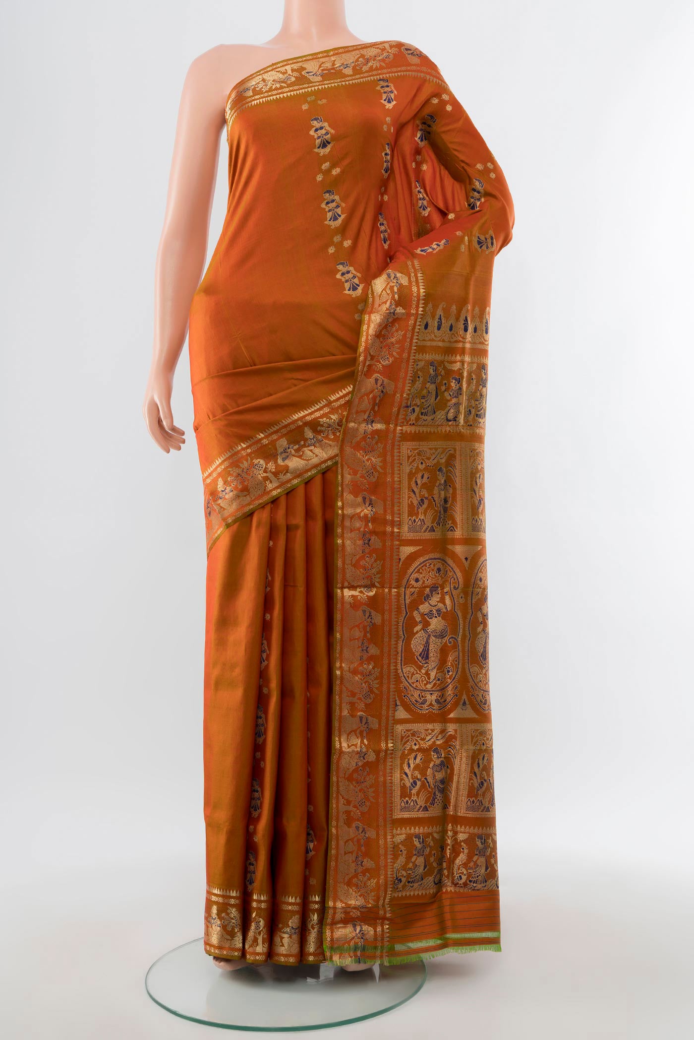 Mustard Baluchari Silk Saree with Zari And Thread Butta on the body and Zari Border.  displayed on a mannequin