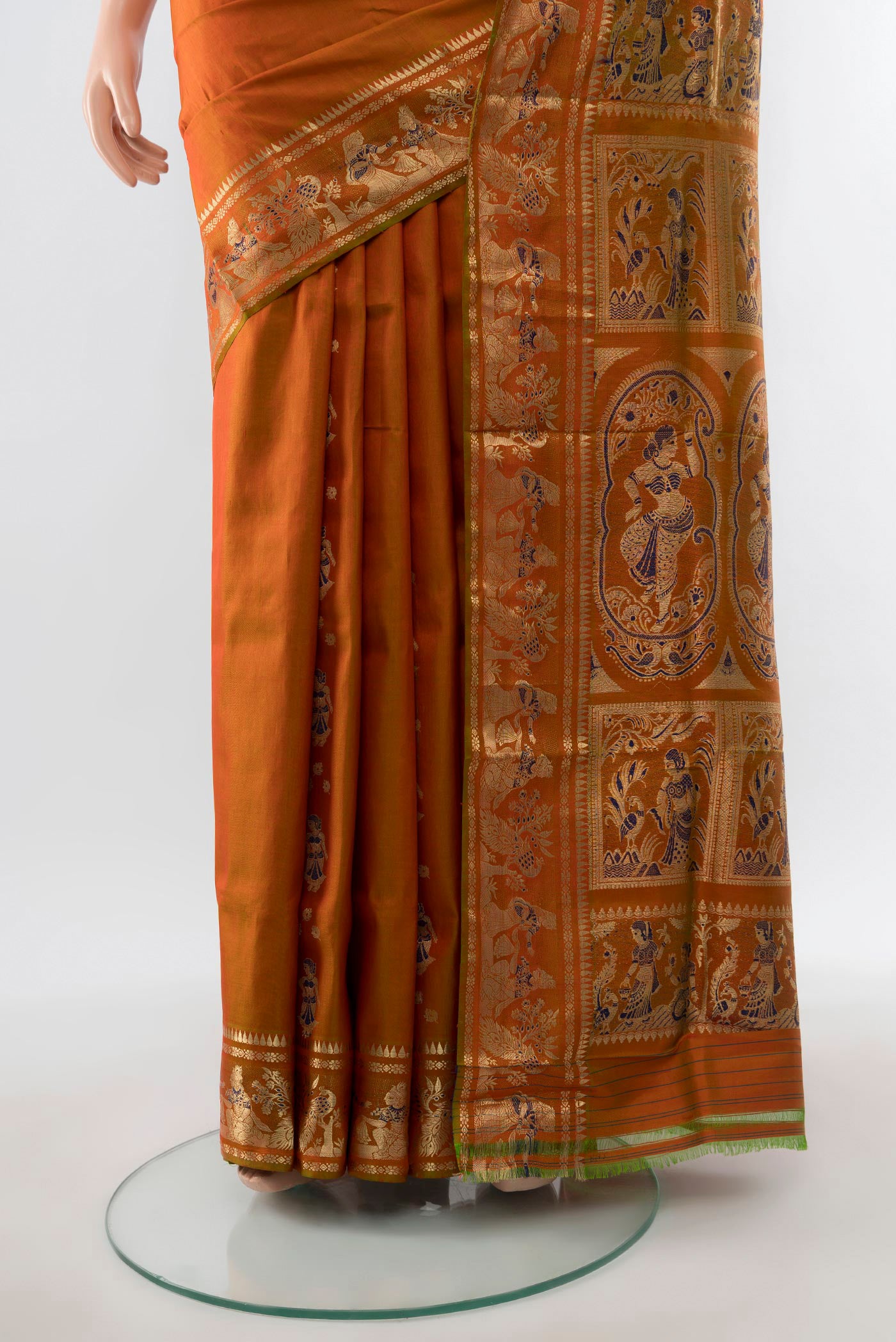 Pleats and pallu of Mustard Baluchari Silk Saree with Zari And Thread Butta on the body and Zari Border. 