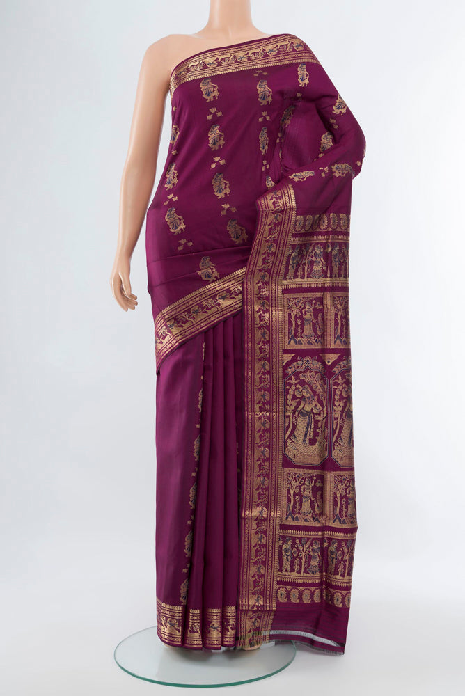 Purple Baluchari Silk Saree with Zari Butta on the body and Silk Border.  displayed on a mannequin