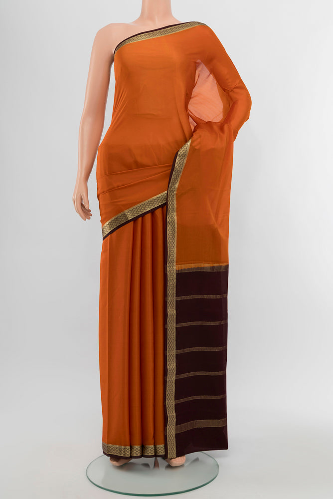 Rust Mysore Crepe Saree with Plain Body and Silk Border.  displayed on a mannequin