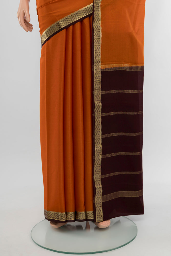 Pleats and pallu of Rust Mysore Crepe Saree with Plain Body and Silk Border. 