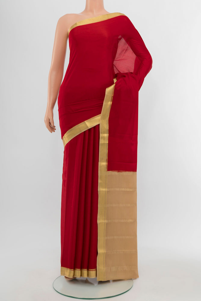 Red Mysore Crepe Saree with Plain Body and Silk Border.  displayed on a mannequin
