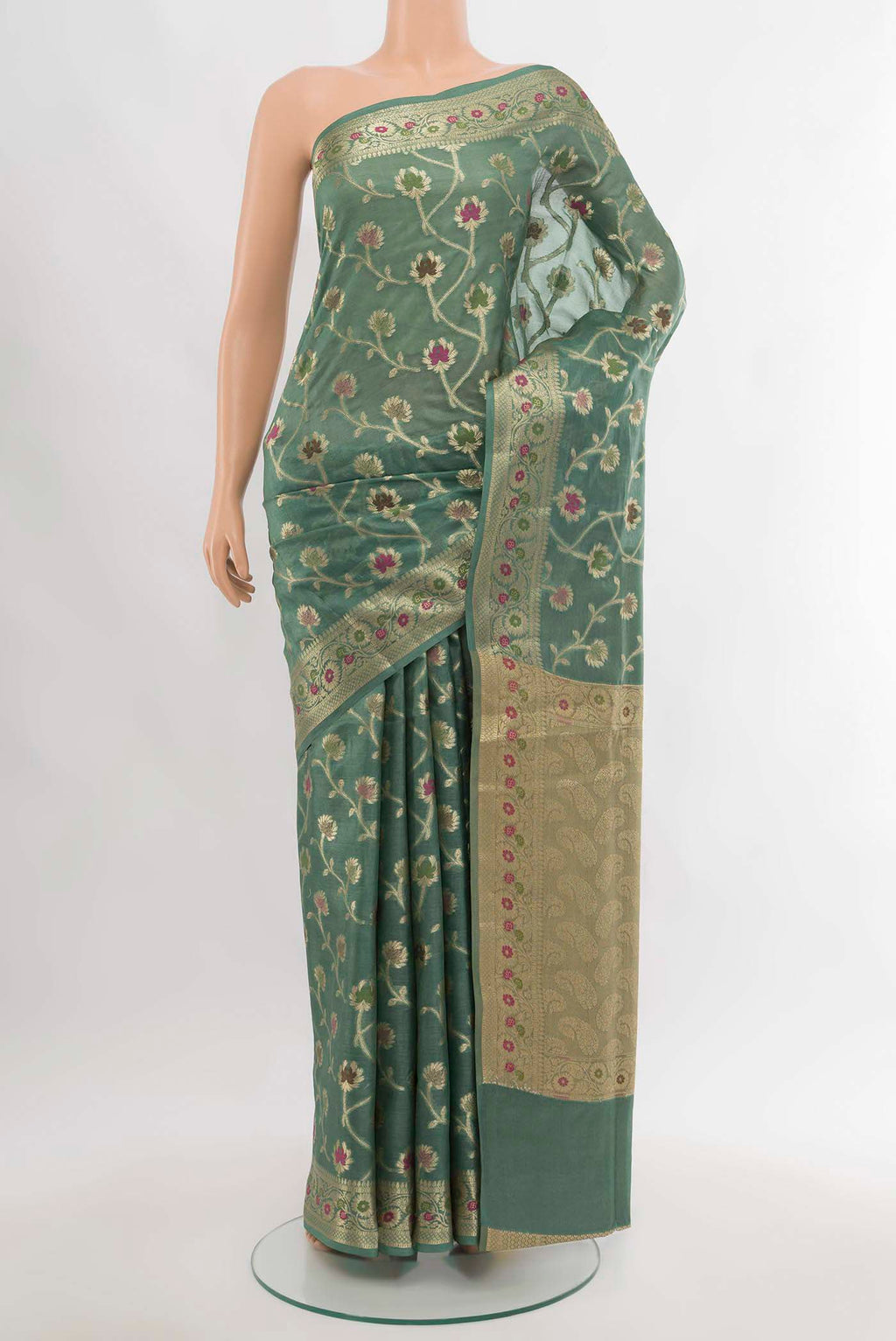 Light Green Banarasi Raw Silk Saree with Zari Butta on the body and Silk Border.  displayed on a mannequin