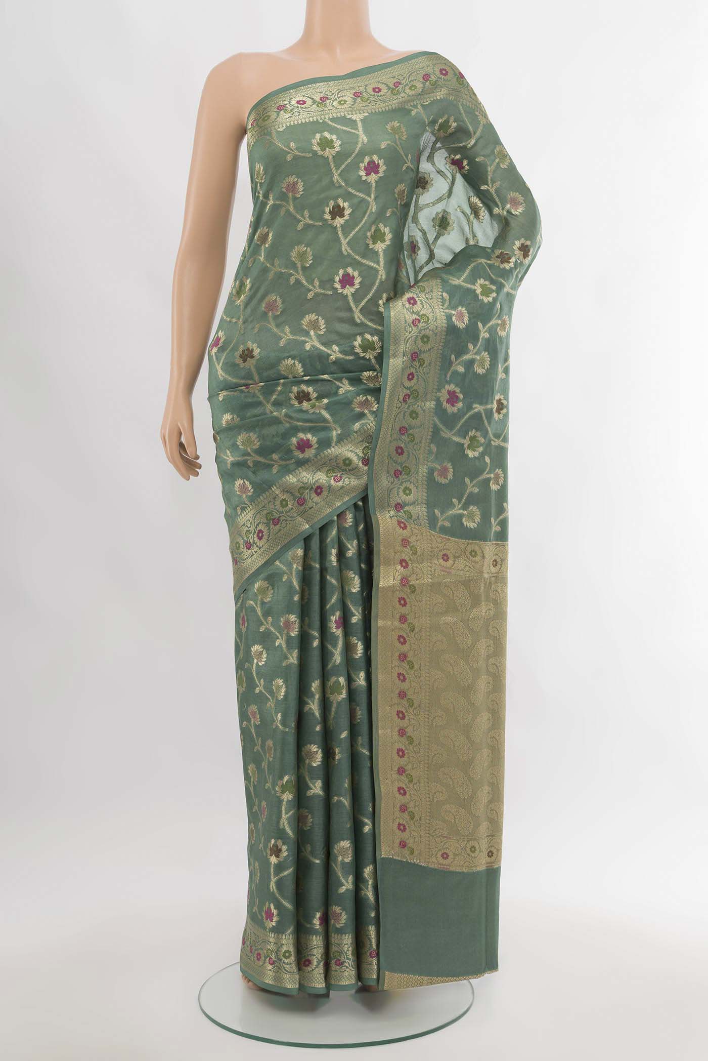 Light Green Banarasi Raw Silk Saree with Zari Butta on the body and Silk Border.  displayed on a mannequin