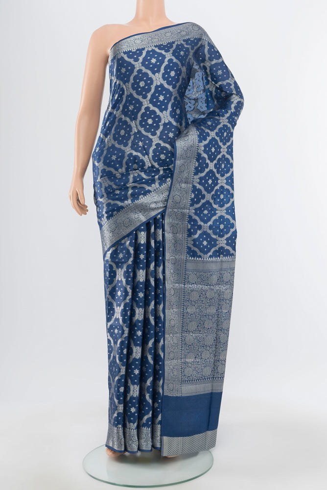 Pure Silk Pure Zari Light Blue Banarasi Raw Saree with Zari Butta on the body and Silk Border.  displayed on a mannequin