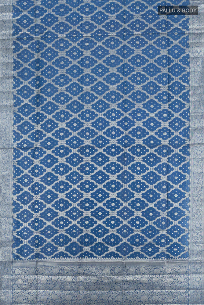 Flat view of Pure Silk Pure Zari Light Blue Banarasi Raw Saree with Zari Butta on the body and Silk Border. 