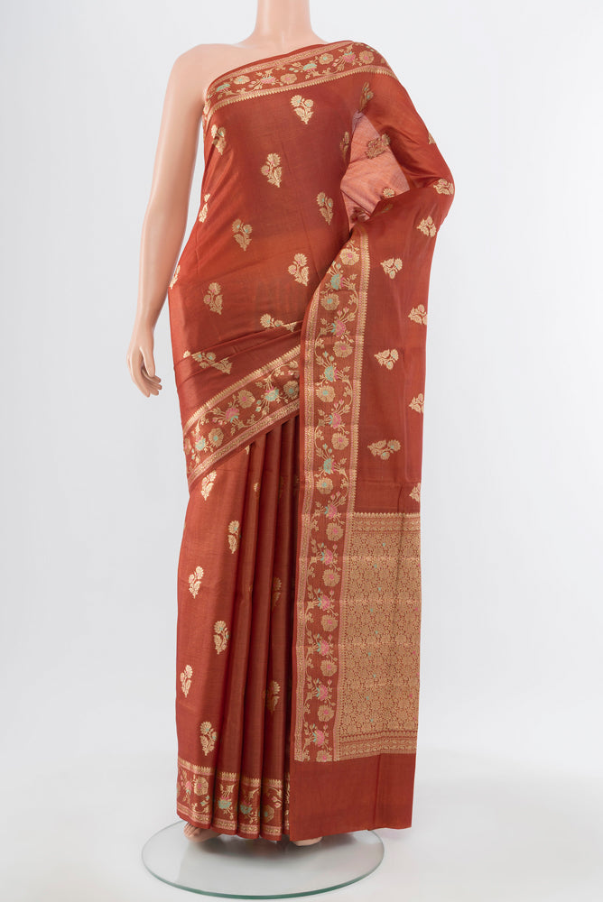 Pure Silk Pure Zari Rust Banarasi Raw Saree with Zari Butta on the body and Silk Border.  displayed on a mannequin