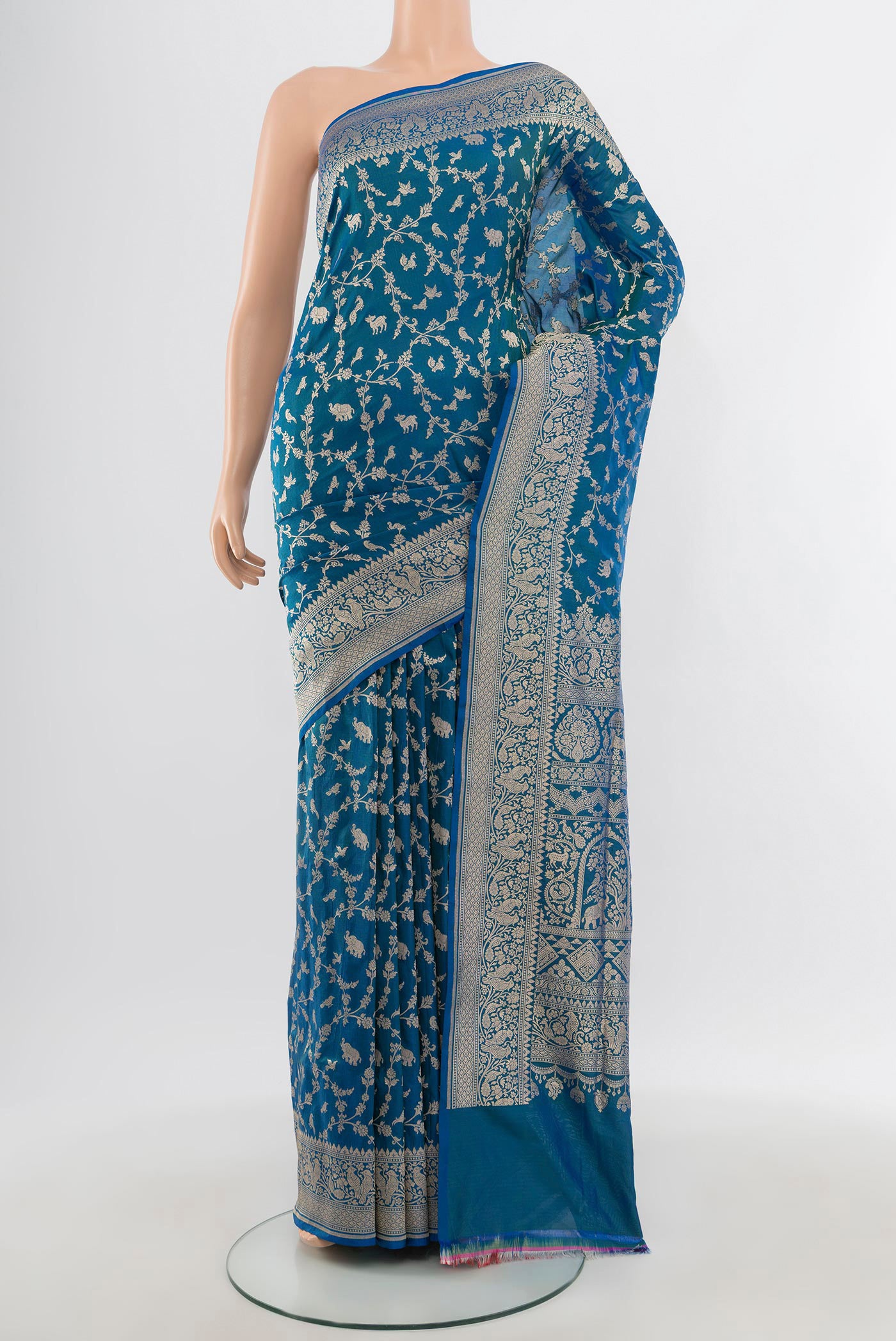 Peacock Blue Banarasi Silk Saree with Zari Brocade on the body and Zari Border.  displayed on a mannequin