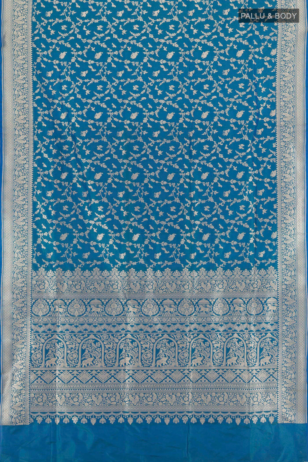 Flat view of Peacock Blue Banarasi Silk Saree with Zari Brocade on the body and Zari Border. 