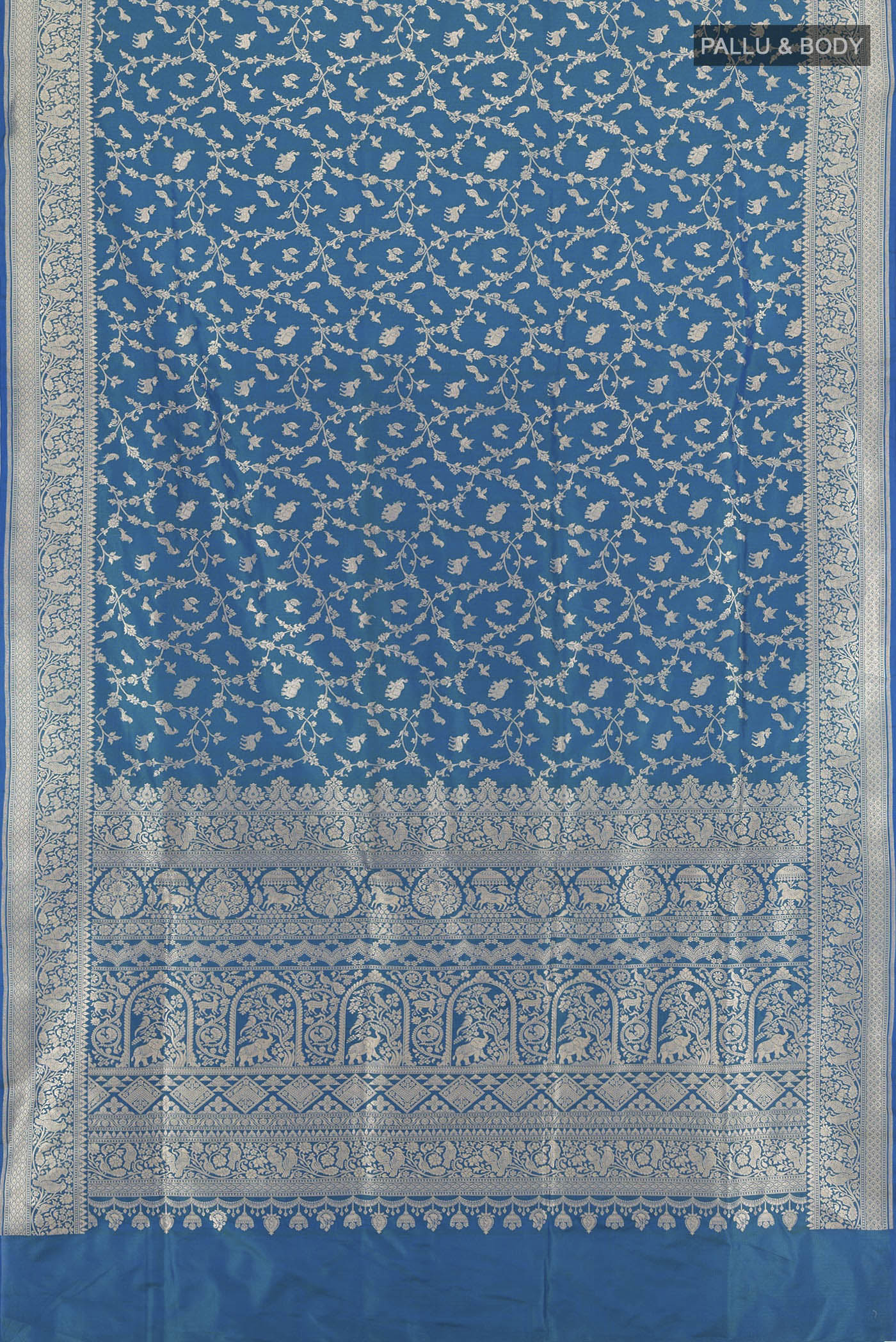 Flat view of Peacock Blue Banarasi Silk Saree with Zari Brocade on the body and Zari Border. 