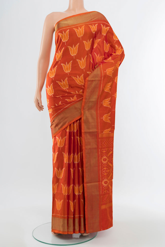 Brick Orange Pochampally Saree with Ikat Print on the body and Silk Border.  displayed on a mannequin