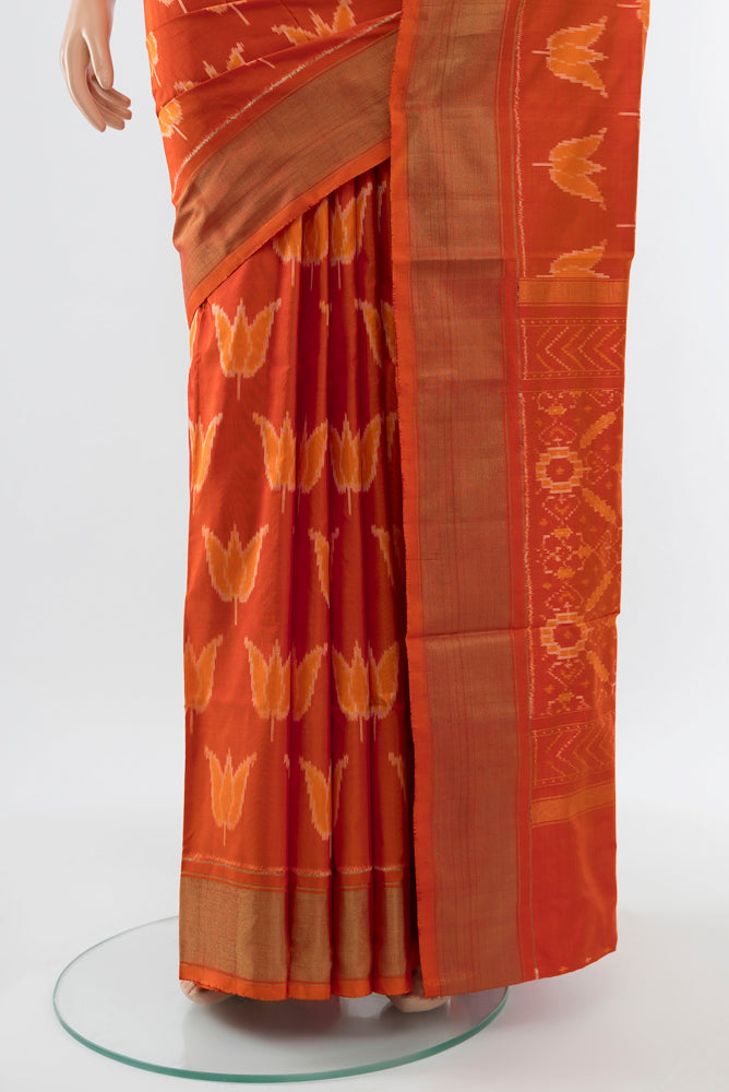 Pleats and pallu of Brick Orange Pochampally Saree with Ikat Print on the body and Silk Border. 