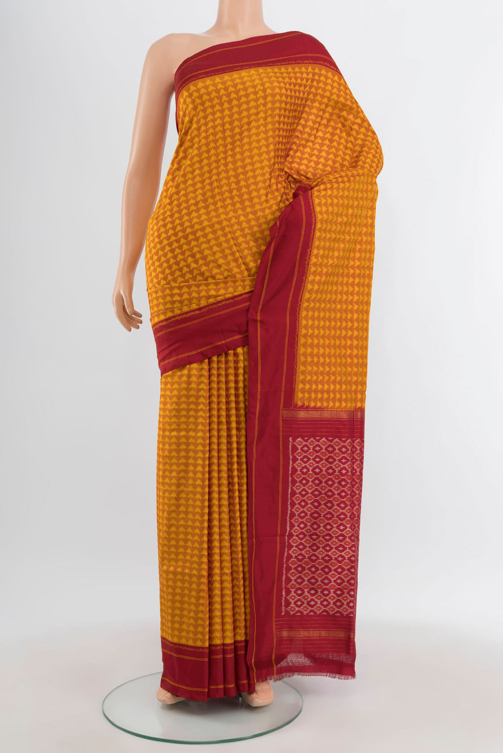 Mustard Pochampally Silk Saree with Pure Ikat on the body and Plain Border.  displayed on a mannequin