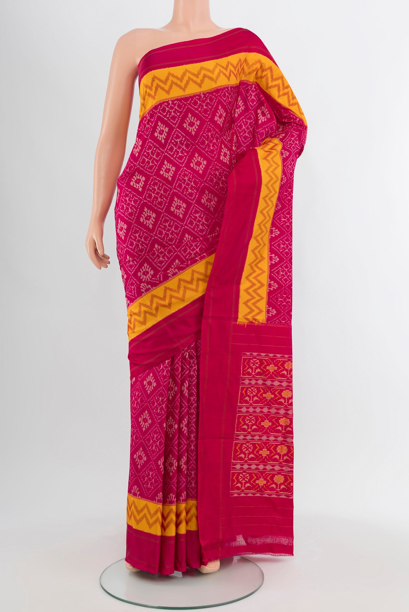 Dark Pink Pochampally Saree with Ikat Print on the body and Silk Border.  displayed on a mannequin