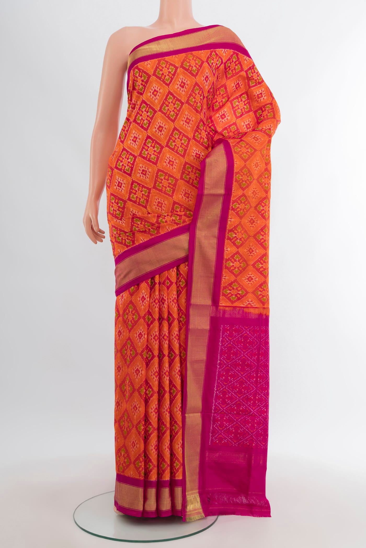 Orange Pochampally Silk Saree with Pure Ikat on the body and Zari Border.  displayed on a mannequin