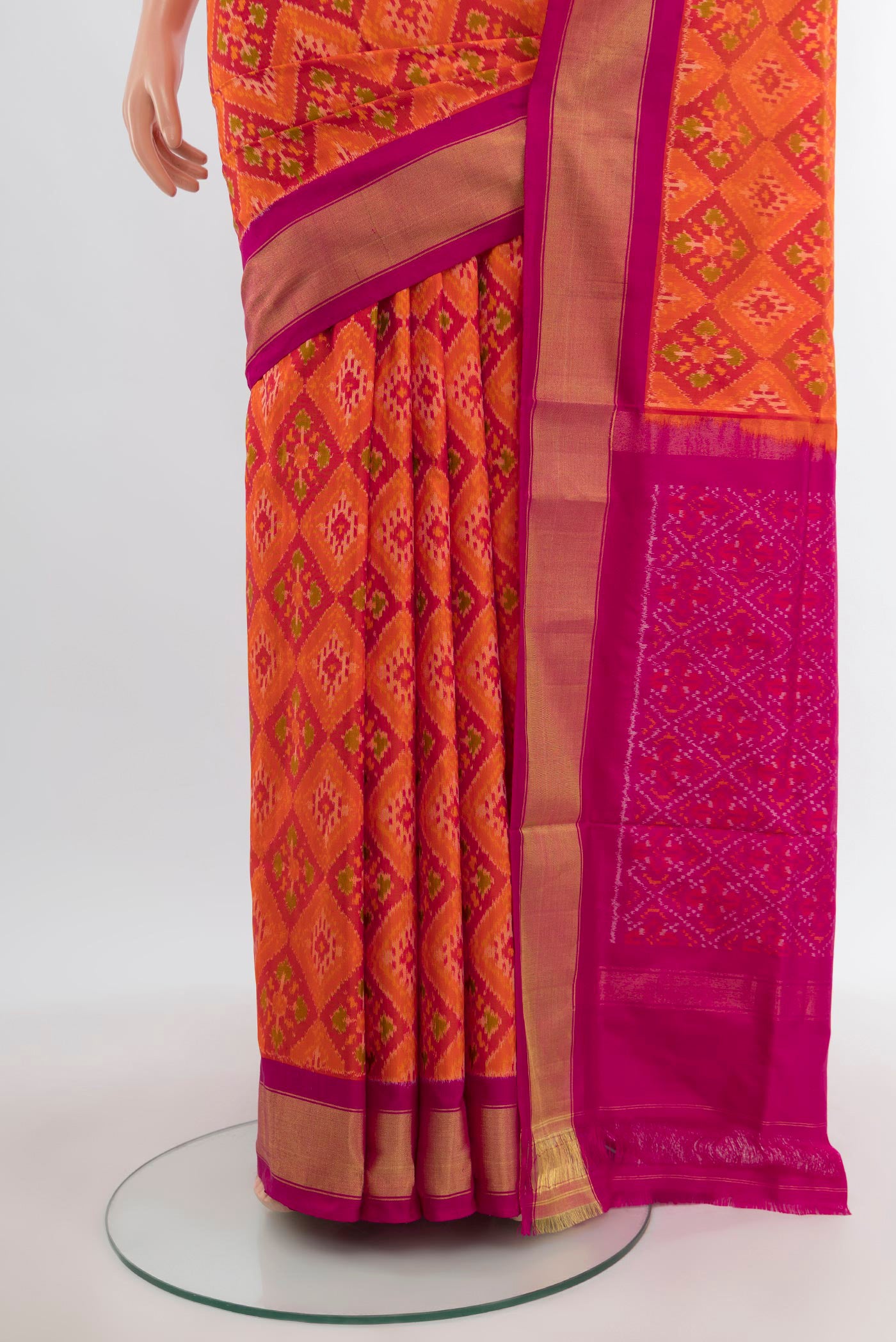 Pleats and pallu of Orange Pochampally Silk Saree with Pure Ikat on the body and Zari Border. 