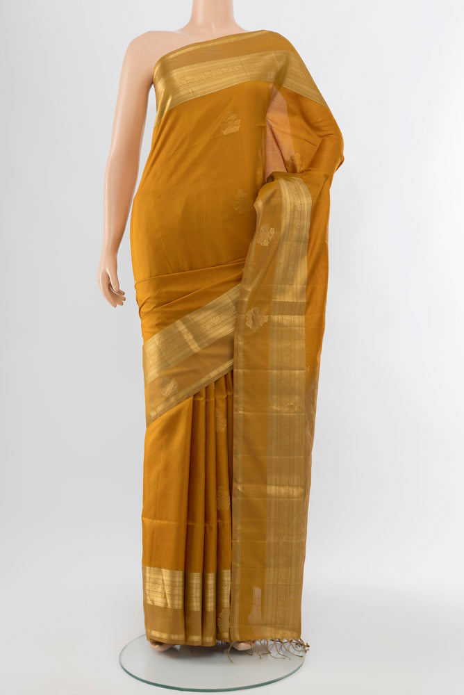 Dark Beige Soft Silk Saree with Zari Butta on the body and Silk Border.  displayed on a mannequin