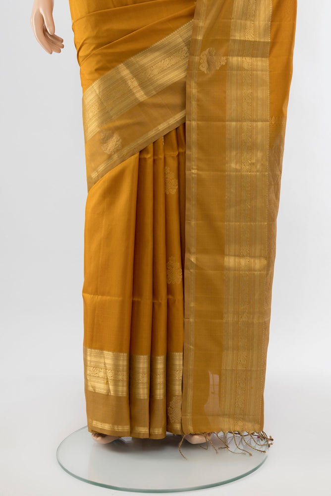 Pleats and pallu of Dark Beige Soft Silk Saree with Zari Butta on the body and Silk Border. 