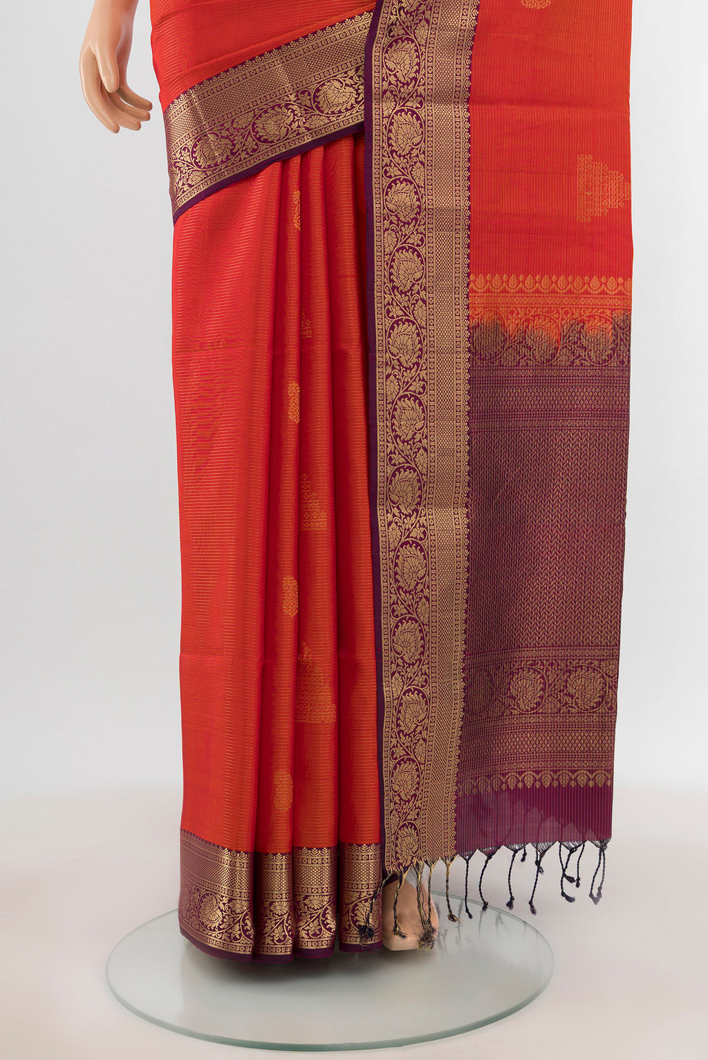 Pleats and pallu of Brick Orange Soft Silk Saree with Zari Butta on the body and Zari Border. 