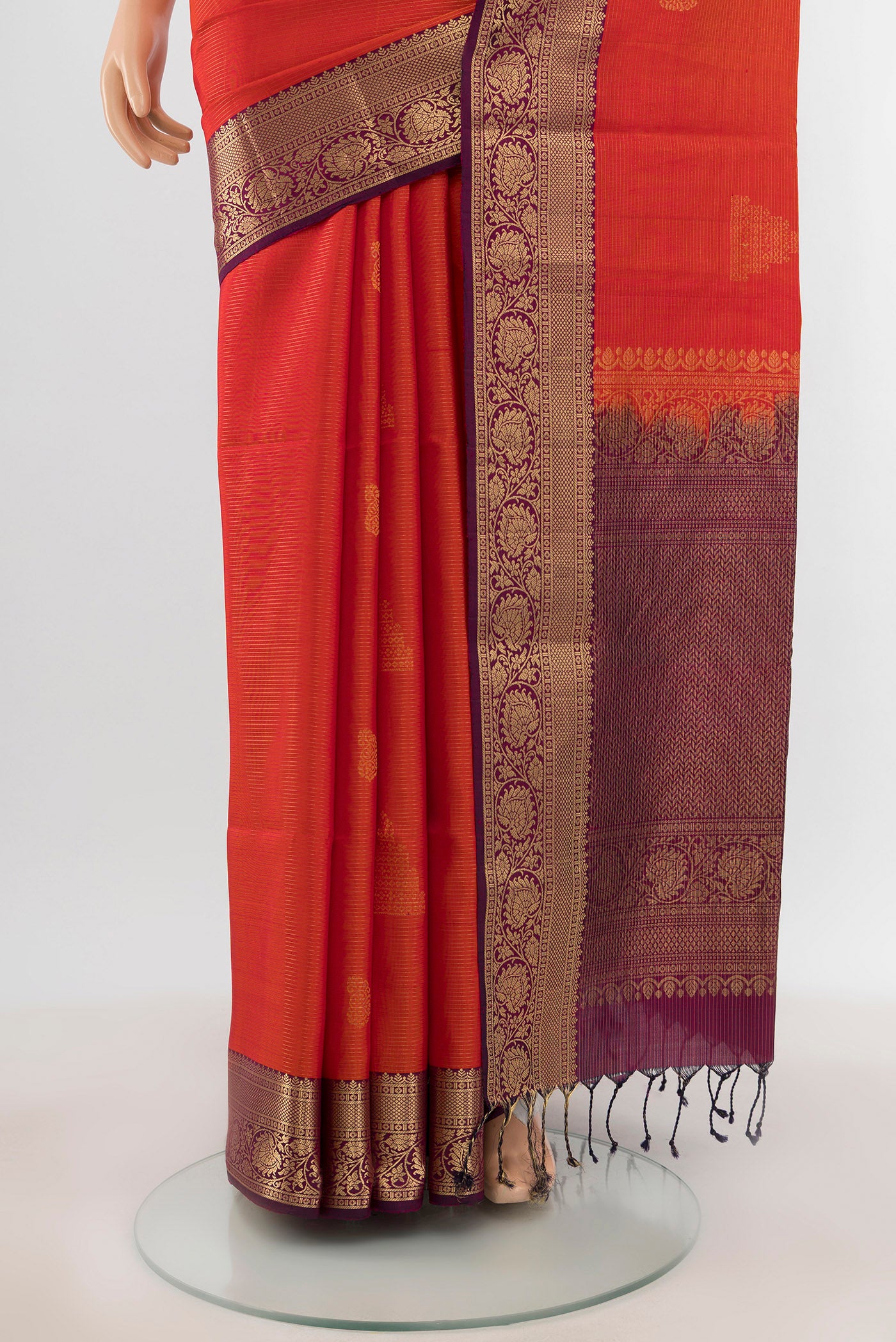 Pleats and pallu of Brick Orange Soft Silk Saree with Zari Butta on the body and Zari Border. 