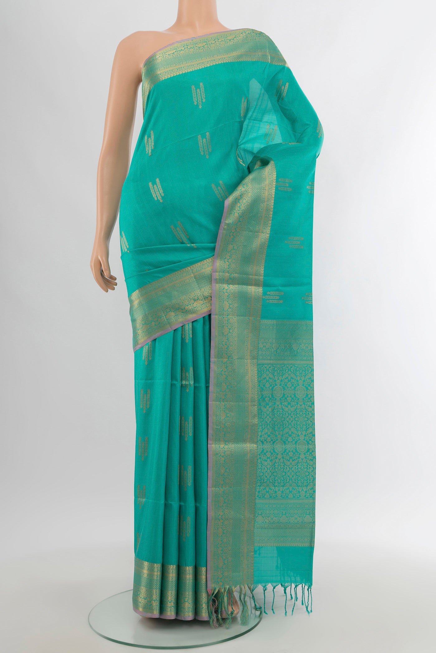 Sky Blue Soft Silk Saree with Zari Butta on the body and Zari Border.  displayed on a mannequin
