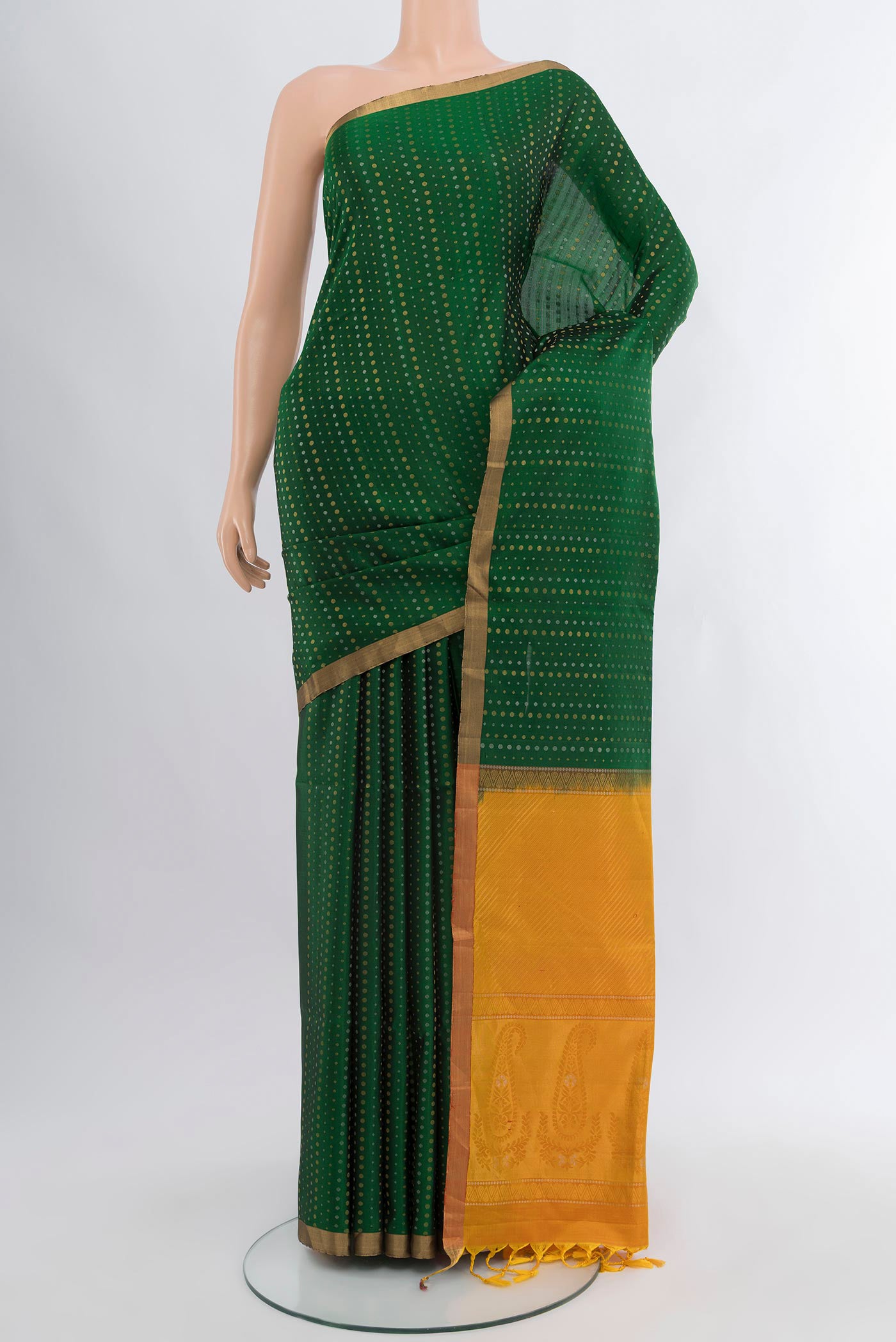 Bottle Green Soft Silk Saree with Zari Butta on the body and Zari Border.  displayed on a mannequin