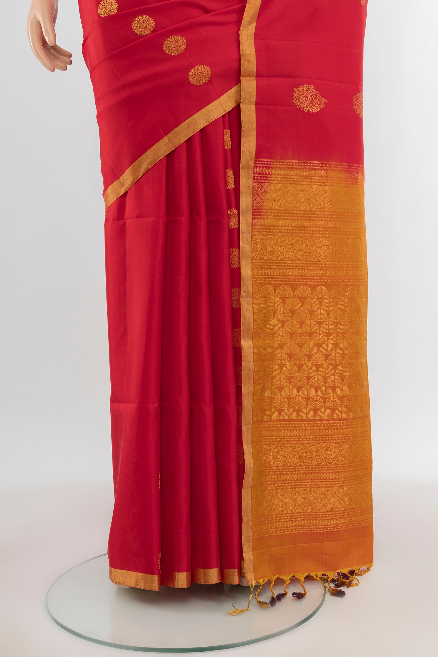 Pleats and pallu of Red Soft Silk Saree with Zari Butta on the body and Zari Border. 