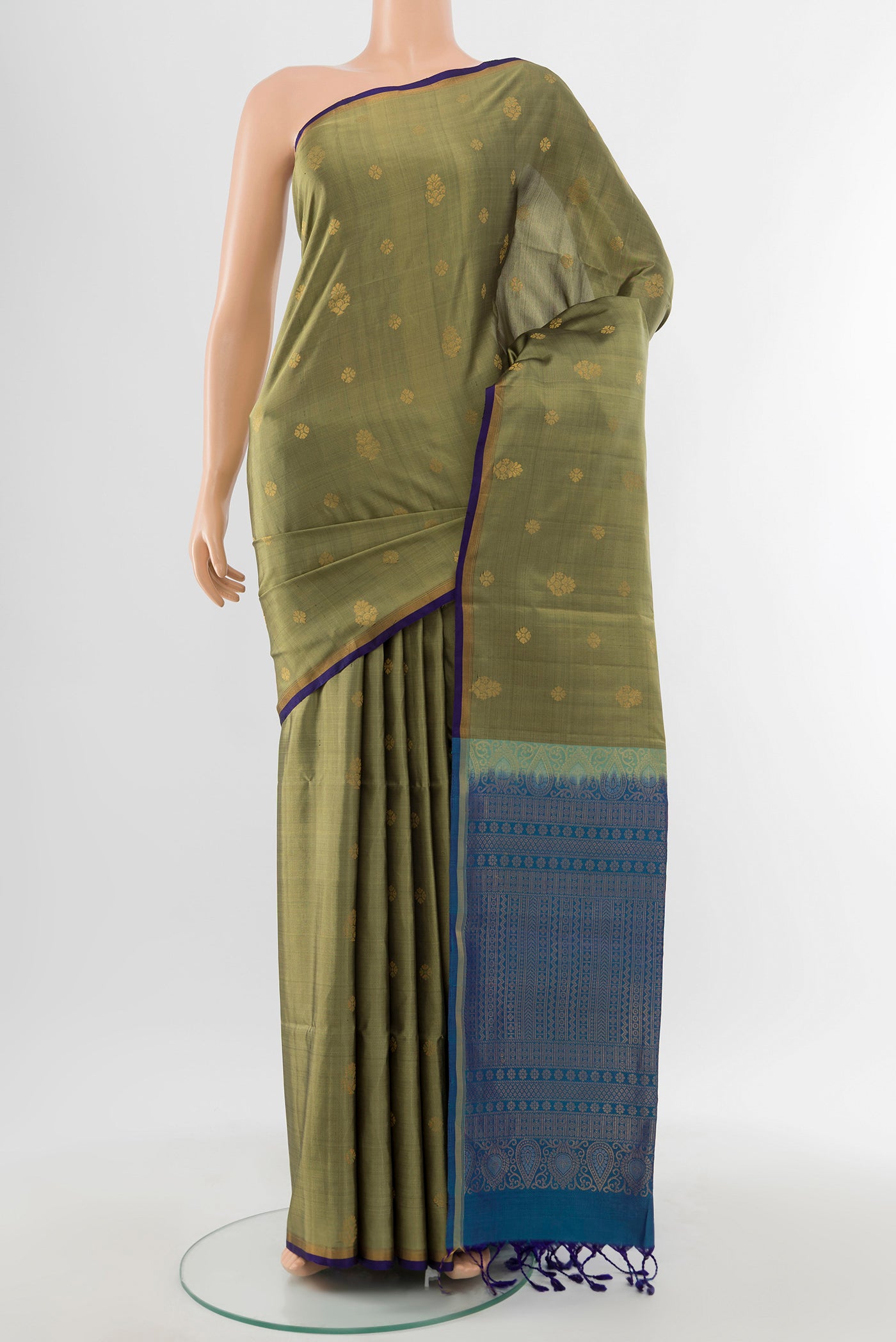Light Green Soft Silk Saree with Zari Butta on the body and Silk Border.  displayed on a mannequin