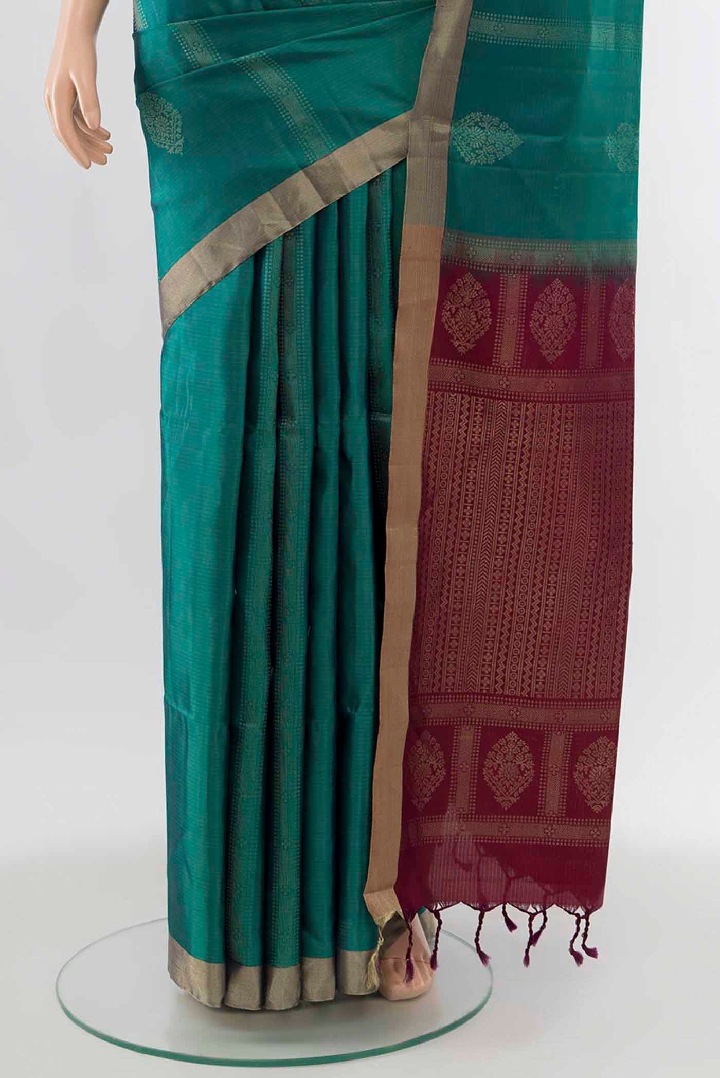 Pleats and pallu of Peacock Blue Soft Silk Saree with Zari Butta on the body and Zari Border