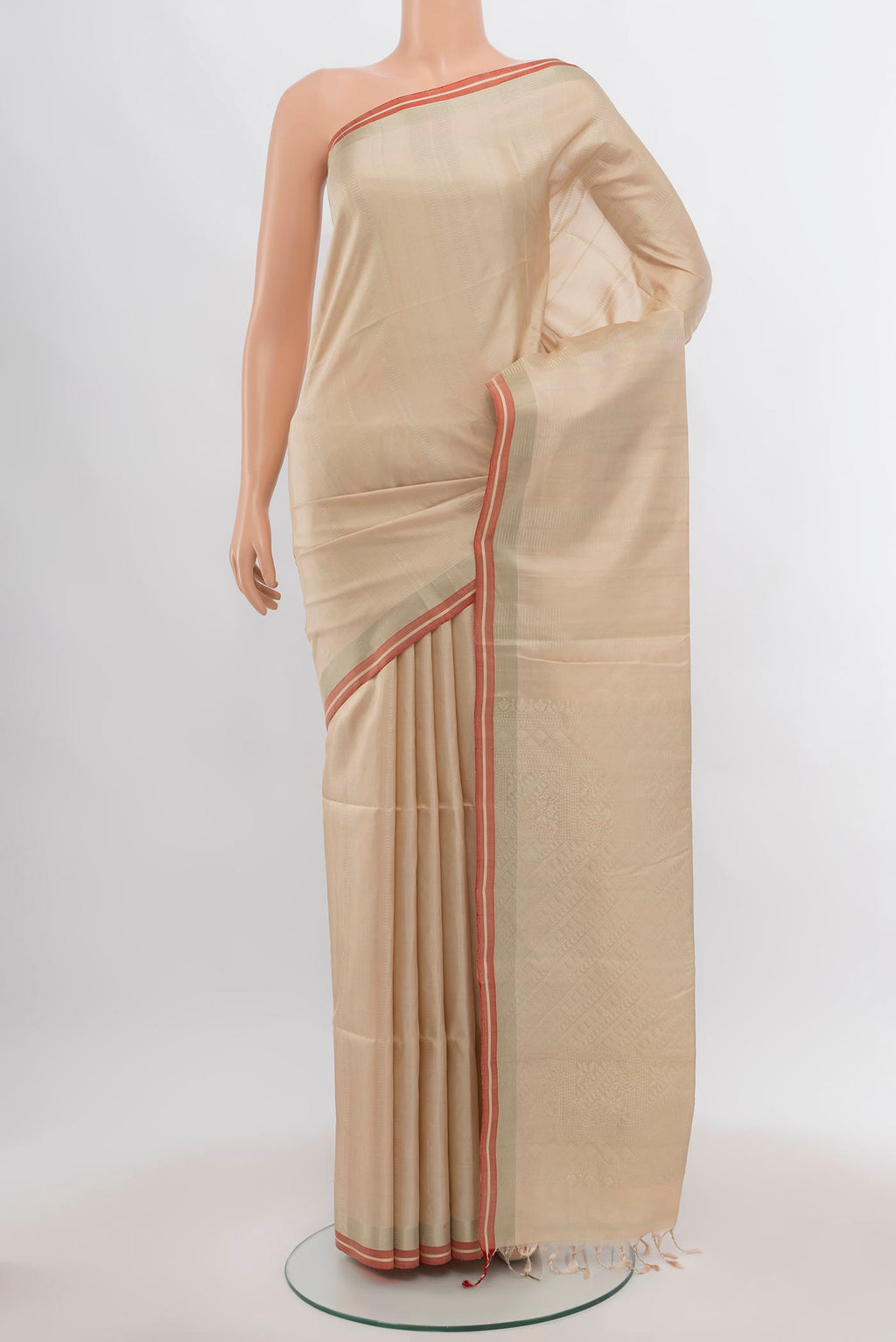 Beige Soft Silk Saree with Zari Butta on the body and Silk Border.  displayed on a mannequin