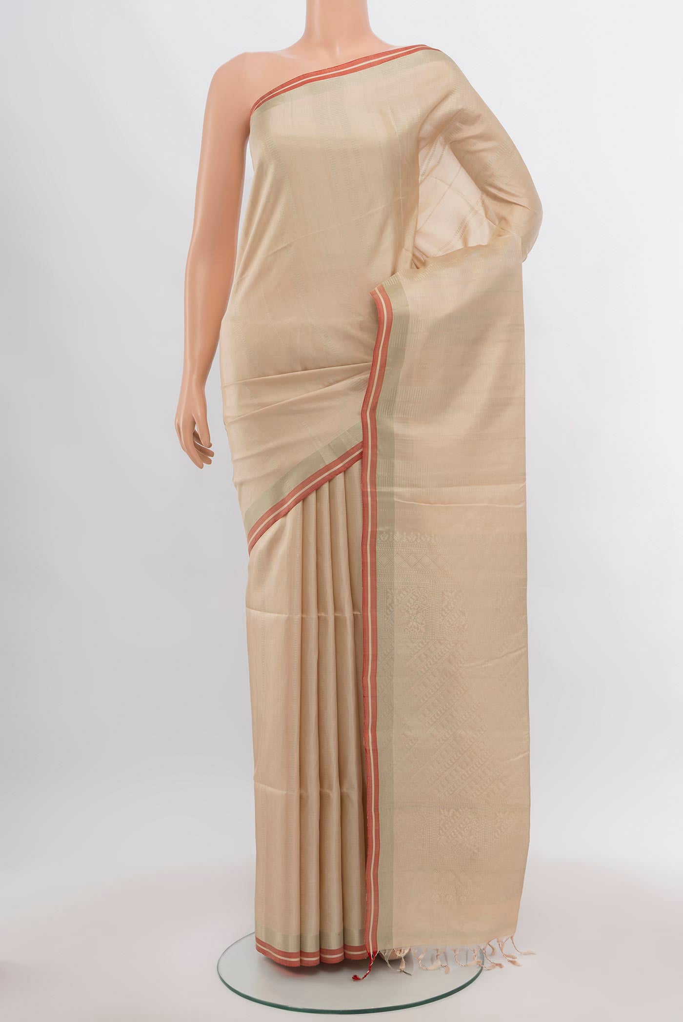 Beige Soft Silk Saree with Zari Butta on the body and Silk Border.  displayed on a mannequin