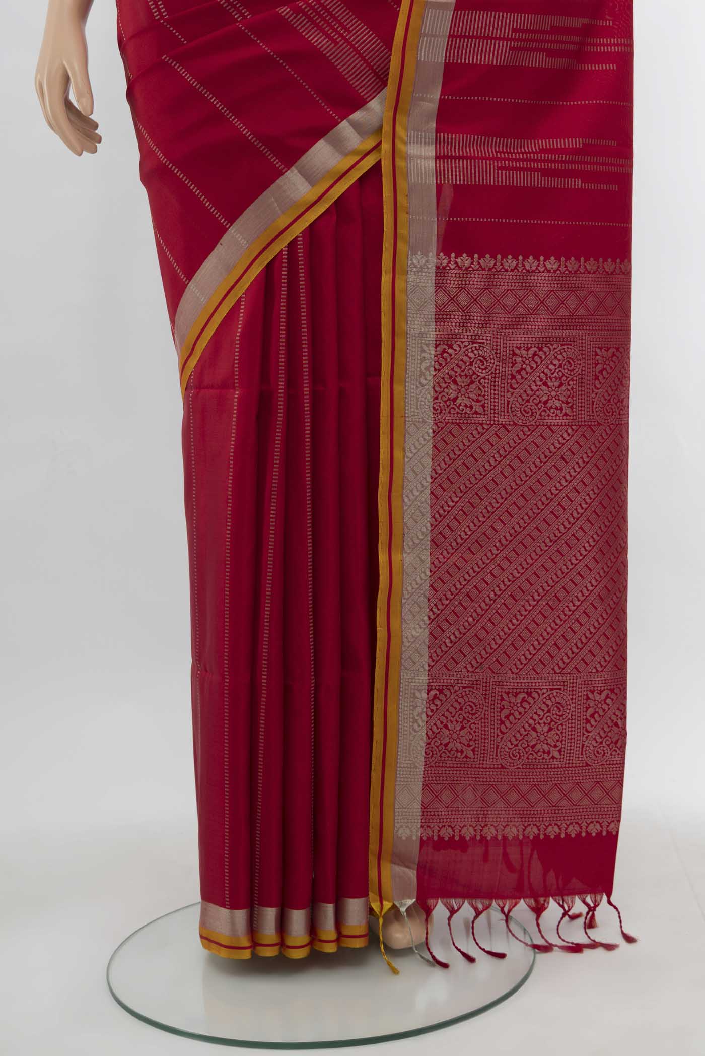 Pleats and pallu of Maroon Soft Silk Saree with Zari Butta on the body and Silk Border. 