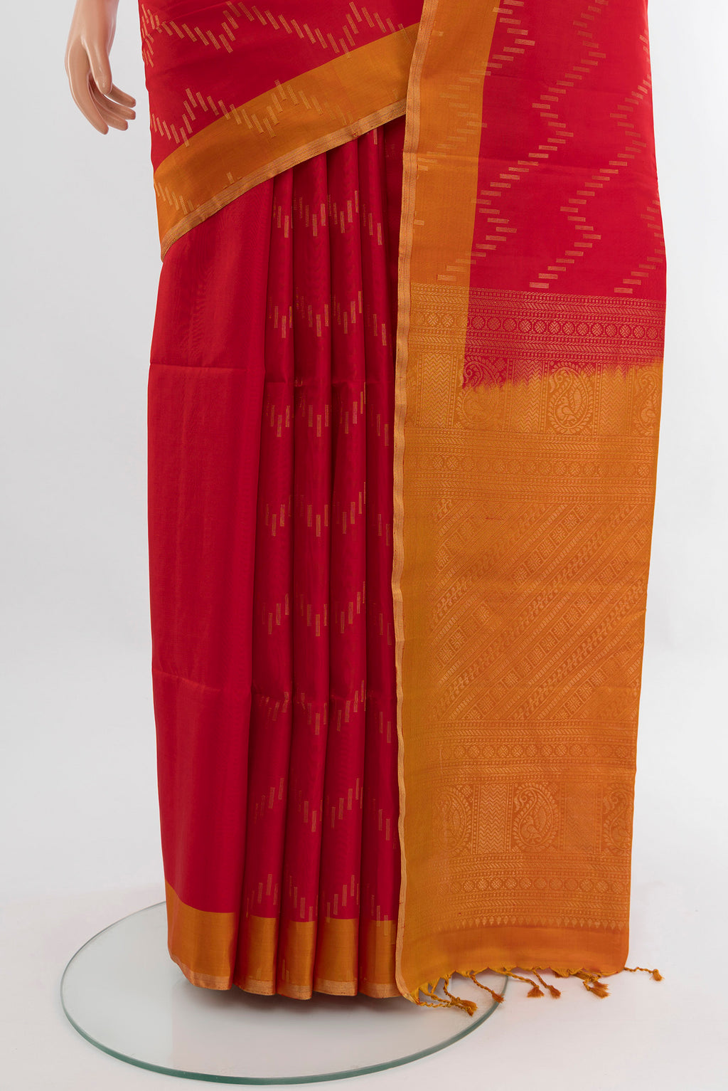 Pleats and pallu of Red Soft Silk Saree with Zari Butta on the body and Zari Border. 