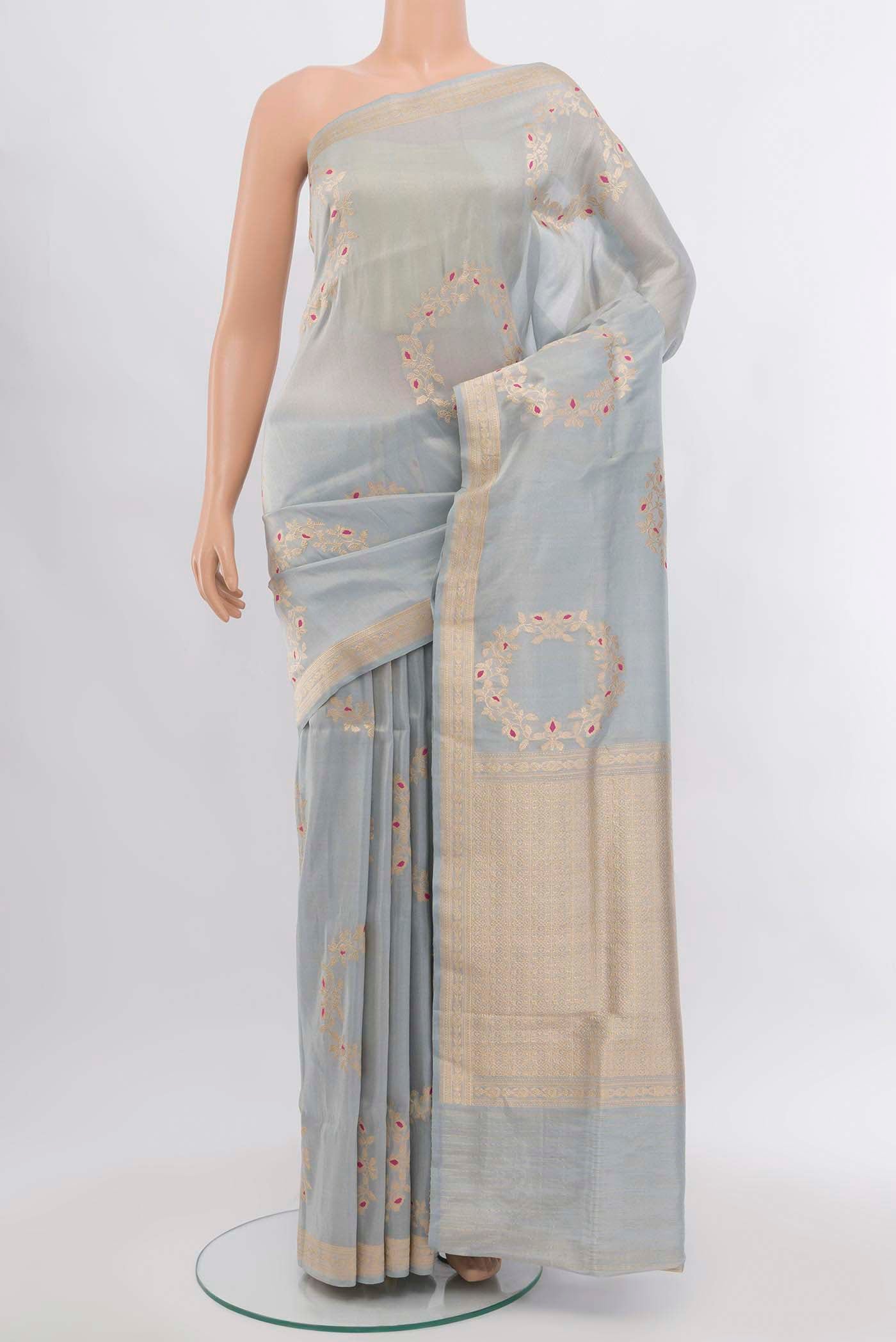 Grey Banarasi Silk Saree with Zari Butta on the body and Silk Border.  displayed on a mannequin