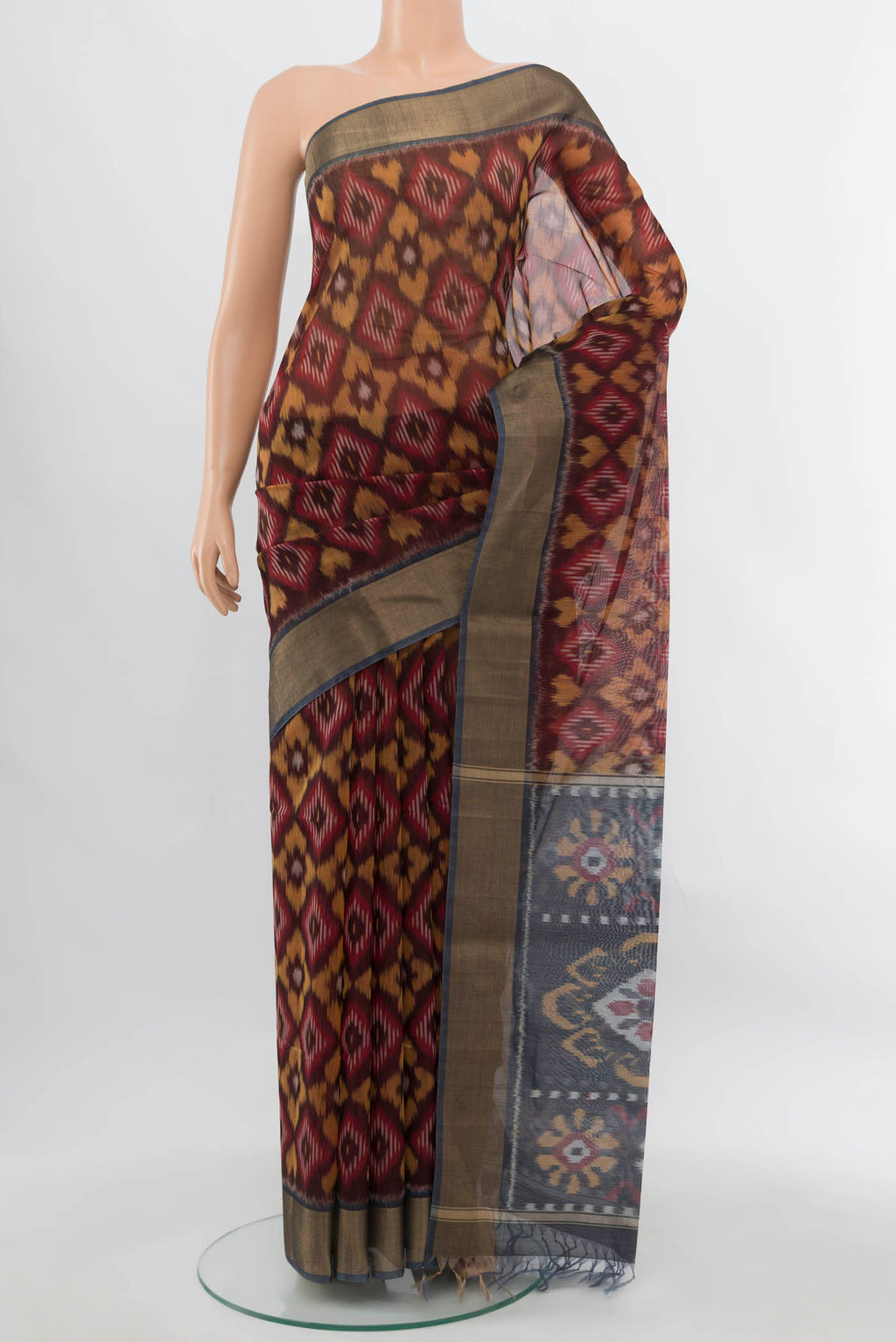 Maroon Maheshwari Silk Cotton Saree with Ikat Print on the body and Silk Border.  displayed on a mannequin
